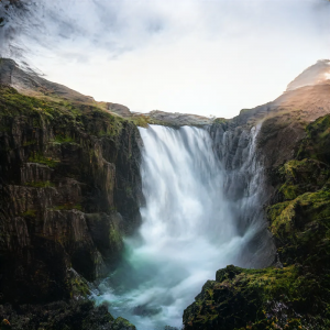 Under the setting sun, the waterfall falls